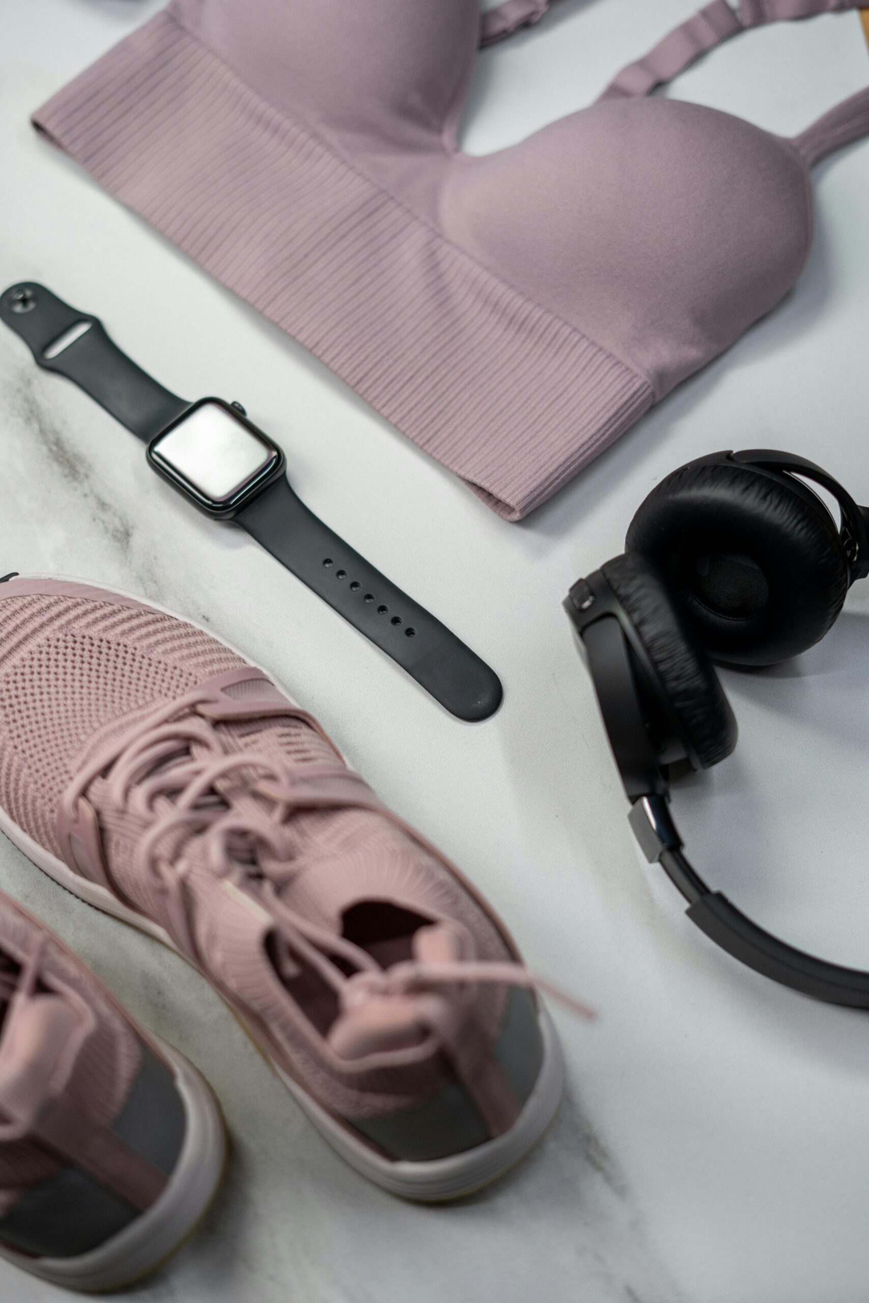 Explore Flat lay of gym essentials with pink sportswear and smartwatch.